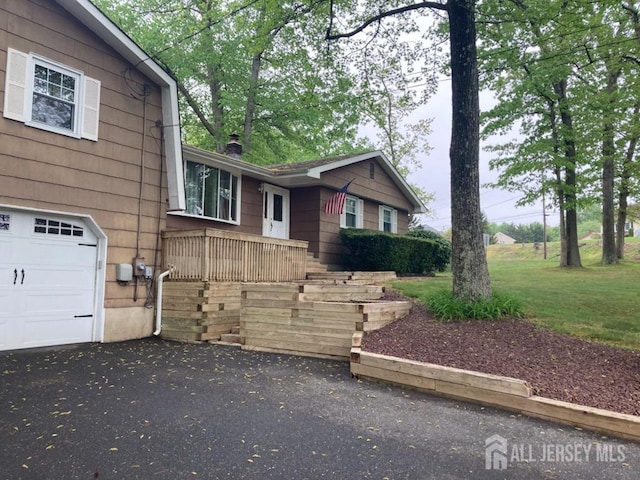 view of property exterior featuring a garage and a chimney