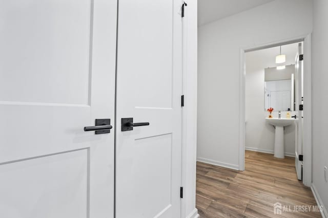 interior space featuring baseboards and wood finished floors