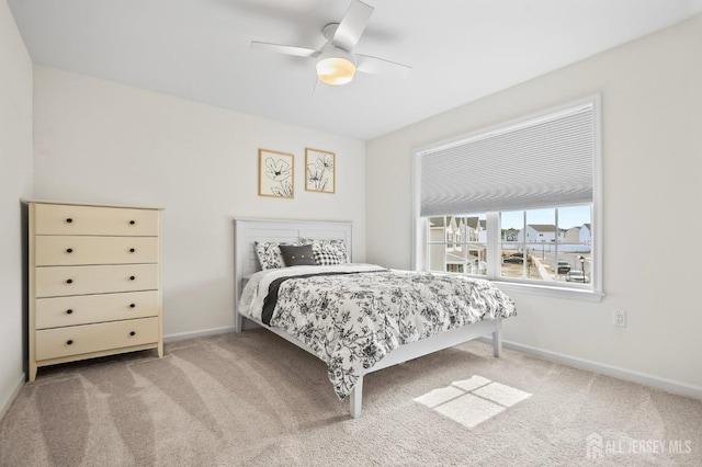 bedroom featuring carpet, baseboards, and a ceiling fan