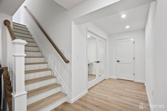 stairway featuring recessed lighting, french doors, baseboards, and wood finished floors