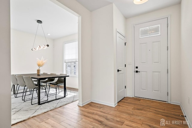 entryway featuring wood finished floors and baseboards