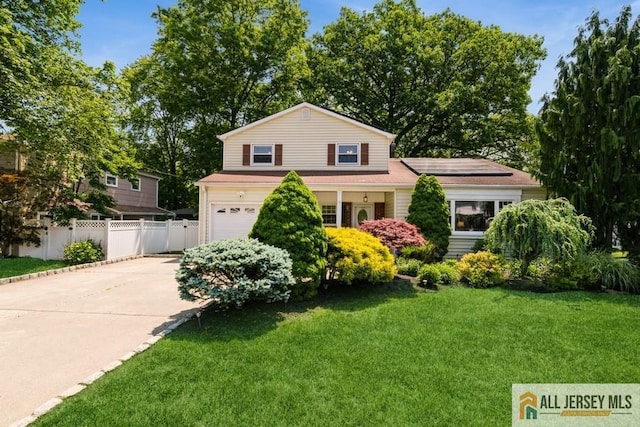 34 Arvin Rd, Old Bridge, NJ 08857 - view of front of property featuring an attached garage, roof mounted solar panels, and concrete driveway