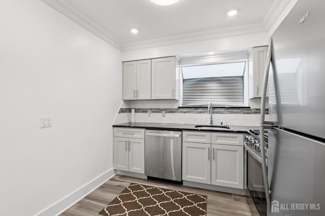 101 Country Club Dr Unit 6, Union Twp, NJ 07083 - kitchen featuring stainless steel appliances, dark countertops, crown molding, decorative backsplash, and light wood-style floors