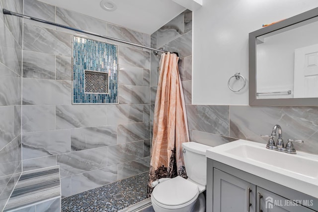 bathroom with tasteful backsplash, tile walls, vanity, walk in shower, and toilet