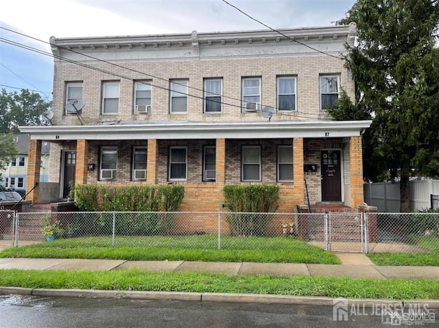 82 Pulaski Ave, Carteret, NJ 07008 - view of property with covered porch, brick siding, a gate, and a fenced front yard