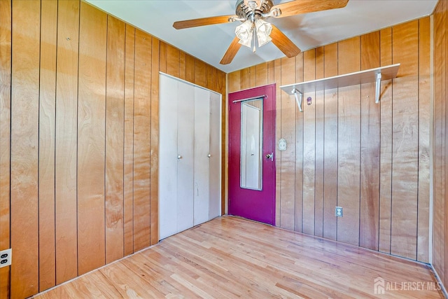 14 Mcginnis Rd, Edison, NJ 08817 - unfurnished bedroom with wood walls, wood finished floors, and a ceiling fan