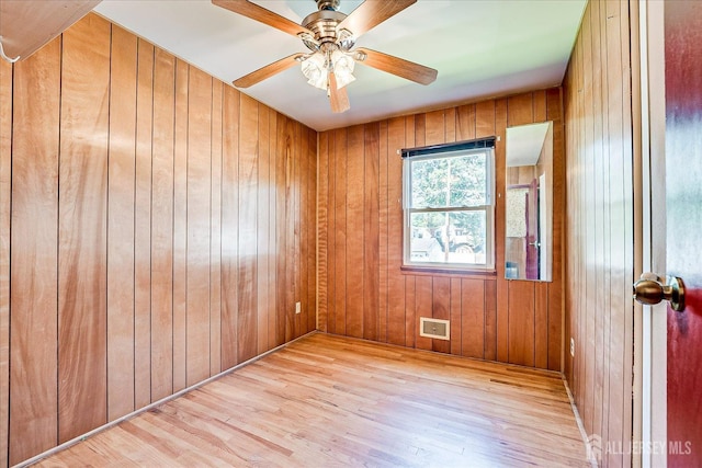 14 Mcginnis Rd, Edison, NJ 08817 - unfurnished room with light wood-style floors, wood walls, and a ceiling fan