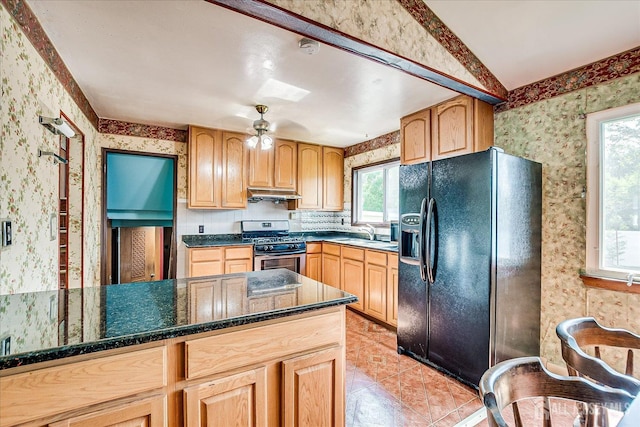 14 Mcginnis Rd, Edison, NJ 08817 - kitchen with black fridge, wallpapered walls, stainless steel gas stove, under cabinet range hood, and light brown cabinetry