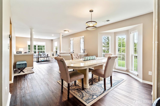 dining space with decorative columns and a wealth of natural light