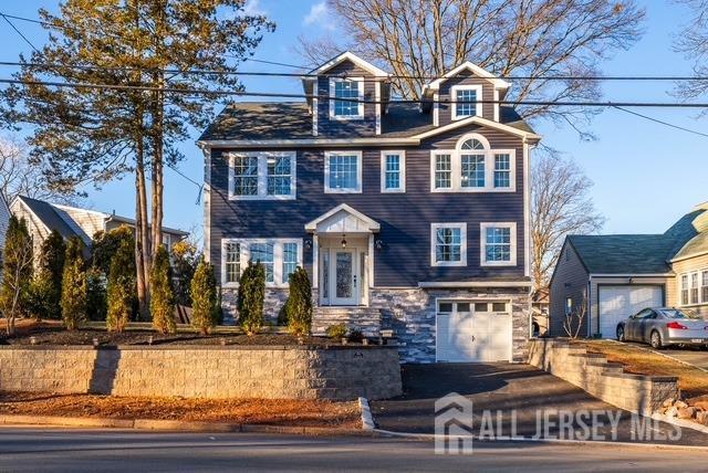 view of front of house featuring stone siding and a garage