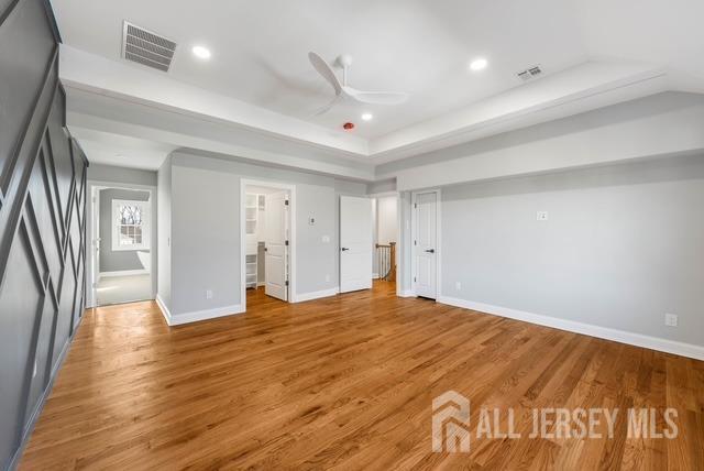 unfurnished bedroom featuring recessed lighting, visible vents, light wood-style flooring, and baseboards