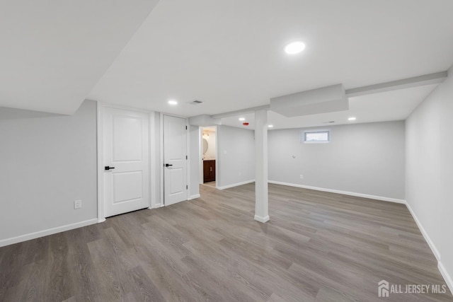 below grade area with baseboards, wood finished floors, and recessed lighting