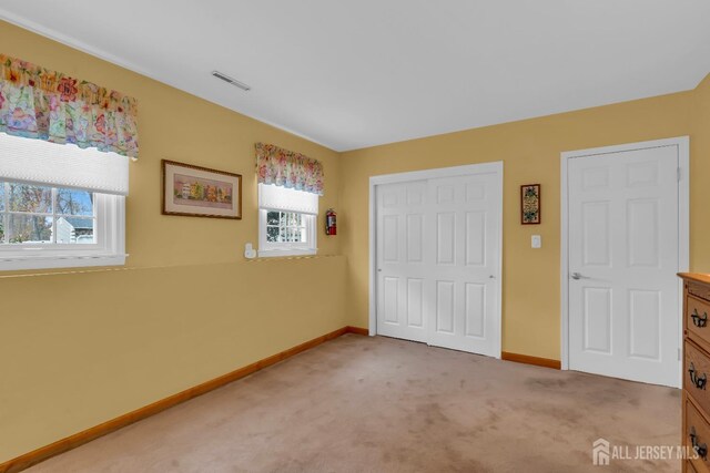 423 Brentwood Dr, Piscataway, NJ 08854 - unfurnished bedroom with light colored carpet, baseboards, and a closet