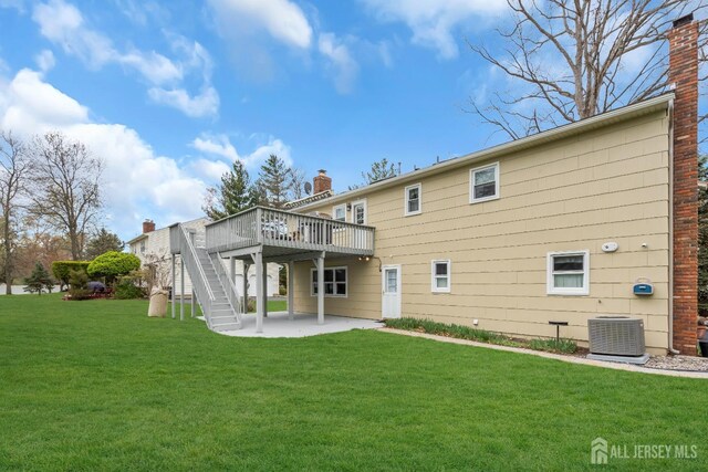 423 Brentwood Dr, Piscataway, NJ 08854 - rear view of property with central AC unit, a wooden deck, a patio area, a yard, and stairway