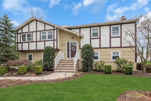 423 Brentwood Dr, Piscataway, NJ 08854 - view of front of house with a chimney, a front lawn, and stucco siding