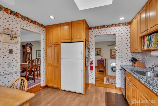 423 Brentwood Dr, Piscataway, NJ 08854 - kitchen featuring freestanding refrigerator, wallpapered walls, a sink, dishwasher, and light wood-style floors