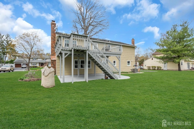 423 Brentwood Dr, Piscataway, NJ 08854 - back of house featuring a chimney, a deck, a lawn, and a patio area