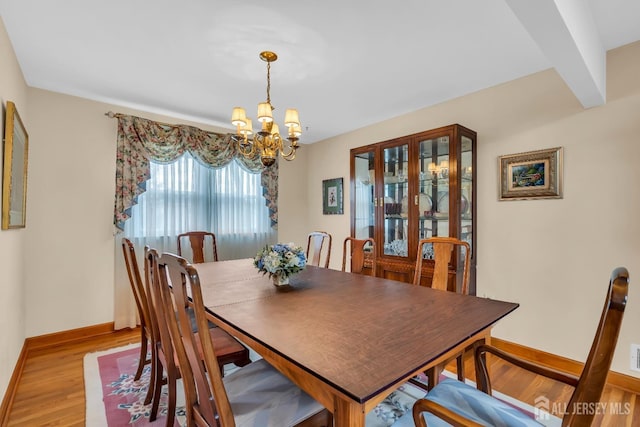 423 Brentwood Dr, Piscataway, NJ 08854 - dining area with a chandelier, wood finished floors, and baseboards