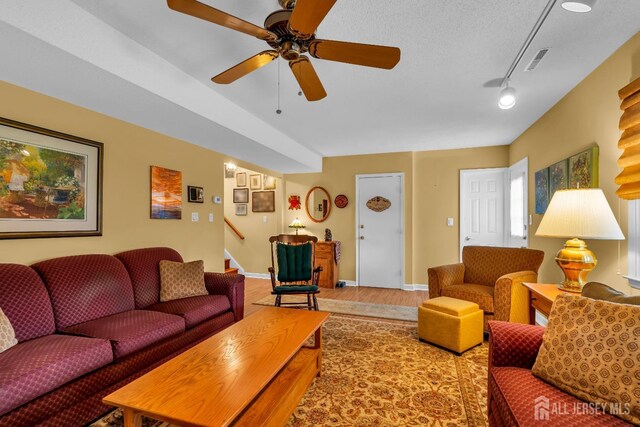 423 Brentwood Dr, Piscataway, NJ 08854 - living room featuring wood finished floors, stairway, baseboards, and ceiling fan