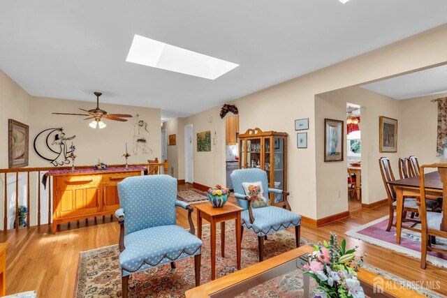 423 Brentwood Dr, Piscataway, NJ 08854 - living area with a skylight, light wood-style flooring, baseboards, and a ceiling fan