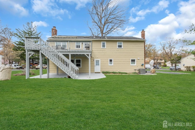 423 Brentwood Dr, Piscataway, NJ 08854 - rear view of property with a chimney, a patio area, central AC, a wooden deck, and a lawn