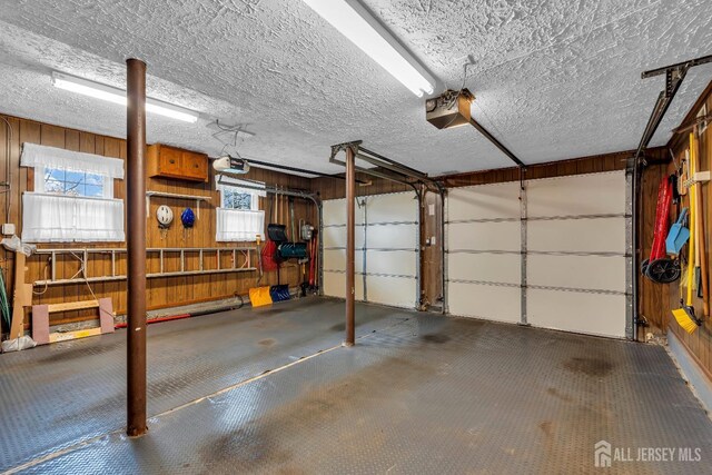 423 Brentwood Dr, Piscataway, NJ 08854 - garage with a garage door opener and wood walls