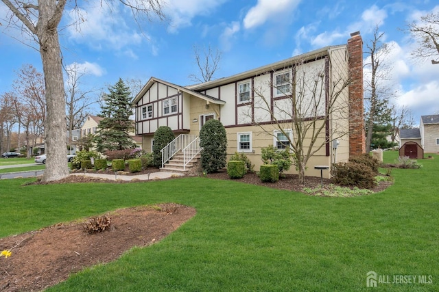 423 Brentwood Dr, Piscataway, NJ 08854 - view of front of house featuring a chimney, a front yard, and stucco siding