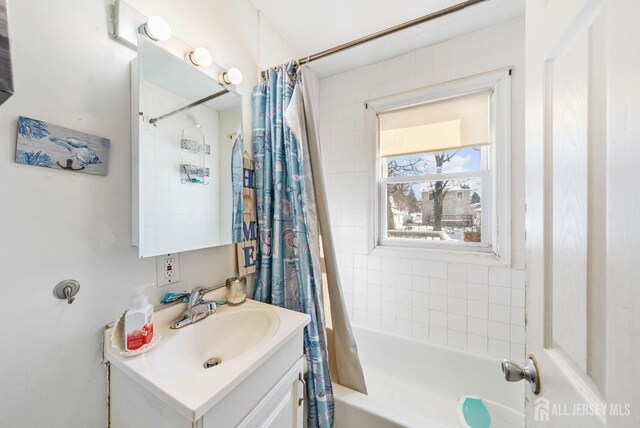 bathroom with shower / bath combo and vanity