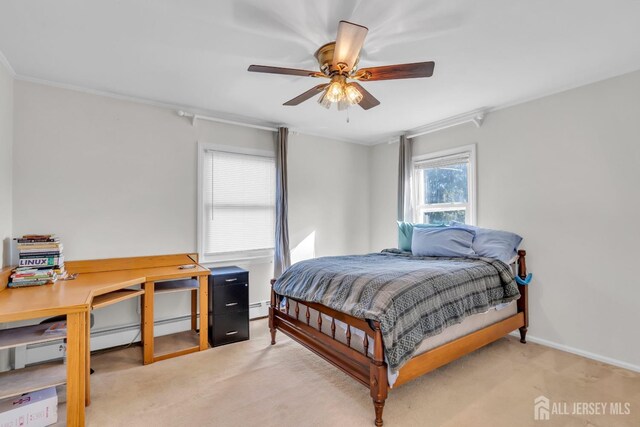 carpeted bedroom featuring baseboard heating, ceiling fan, and ornamental molding