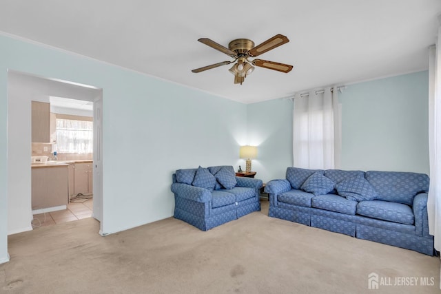 living room featuring ceiling fan and light colored carpet