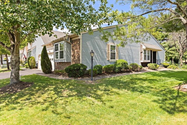 15-A Betsy Ross Dr, Monroe, NJ 08831 - view of front of property featuring a front yard, brick siding, and a garage