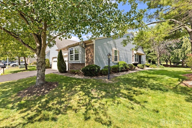 15-A Betsy Ross Dr, Monroe, NJ 08831 - view of front facade with a garage, asphalt driveway, brick siding, and a front lawn