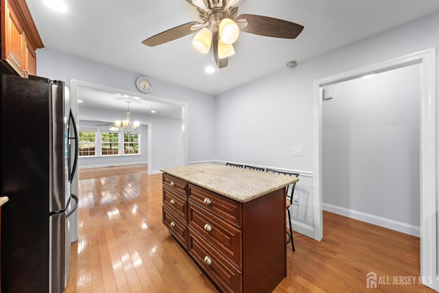 15-A Betsy Ross Dr, Monroe, NJ 08831 - kitchen with freestanding refrigerator, a breakfast bar, light wood-type flooring, a chandelier, and recessed lighting