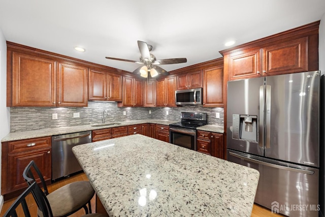 15-A Betsy Ross Dr, Monroe, NJ 08831 - kitchen with stainless steel appliances, a sink, ceiling fan, light stone counters, and decorative backsplash