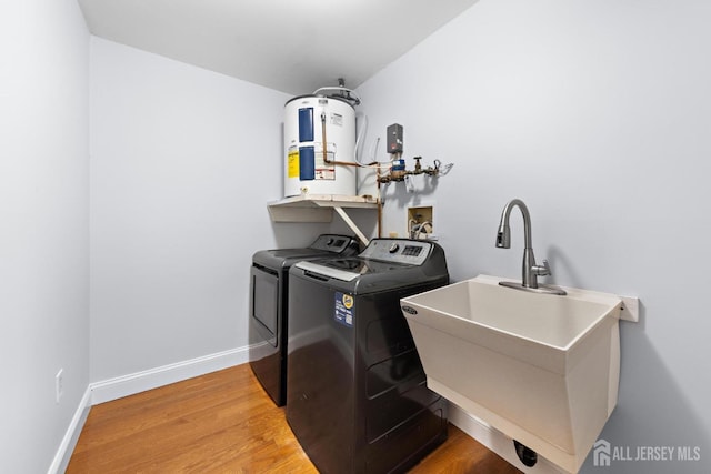 15-A Betsy Ross Dr, Monroe, NJ 08831 - laundry room with water heater, washing machine and clothes dryer, wood finished floors, and baseboards