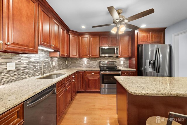 15-A Betsy Ross Dr, Monroe, NJ 08831 - kitchen featuring stainless steel appliances, a sink, light wood finished floors, light stone countertops, and ceiling fan
