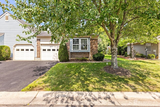 15-A Betsy Ross Dr, Monroe, NJ 08831 - view of property hidden behind natural elements with driveway, brick siding, a front yard, and a garage