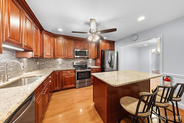 15-A Betsy Ross Dr, Monroe, NJ 08831 - kitchen with appliances with stainless steel finishes, a sink, a breakfast bar, tasteful backsplash, and light wood-style flooring