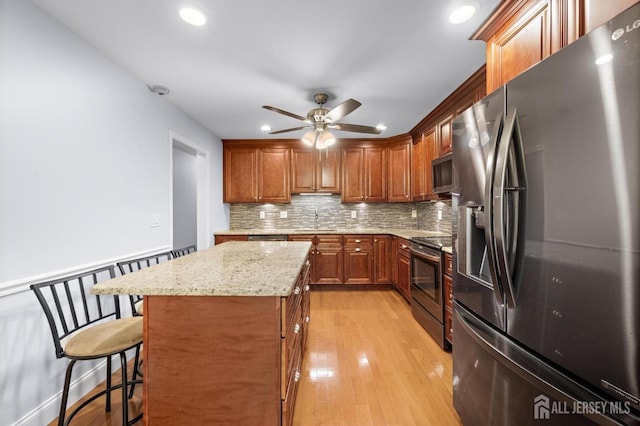 15-A Betsy Ross Dr, Monroe, NJ 08831 - kitchen with appliances with stainless steel finishes, a sink, decorative backsplash, ceiling fan, and a kitchen breakfast bar