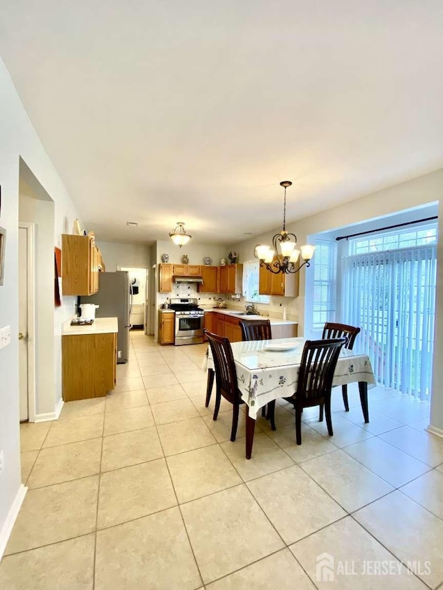57 Yorktown Rd, South Brunswick, NJ 08852 - dining space with a chandelier and light tile patterned floors