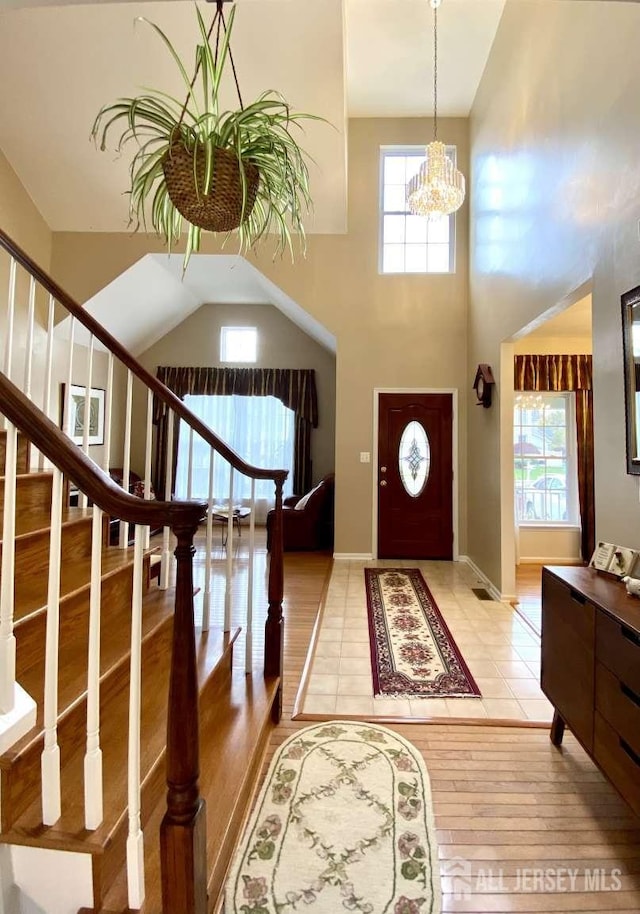 57 Yorktown Rd, South Brunswick, NJ 08852 - foyer with a chandelier, a high ceiling, light wood-type flooring, and stairway
