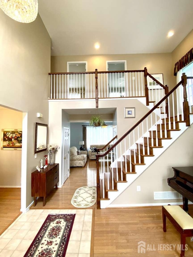 57 Yorktown Rd, South Brunswick, NJ 08852 - stairway with wood finished floors, a high ceiling, and recessed lighting