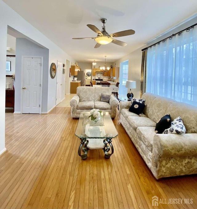 57 Yorktown Rd, South Brunswick, NJ 08852 - living area featuring ceiling fan, light wood-style floors, and a chandelier