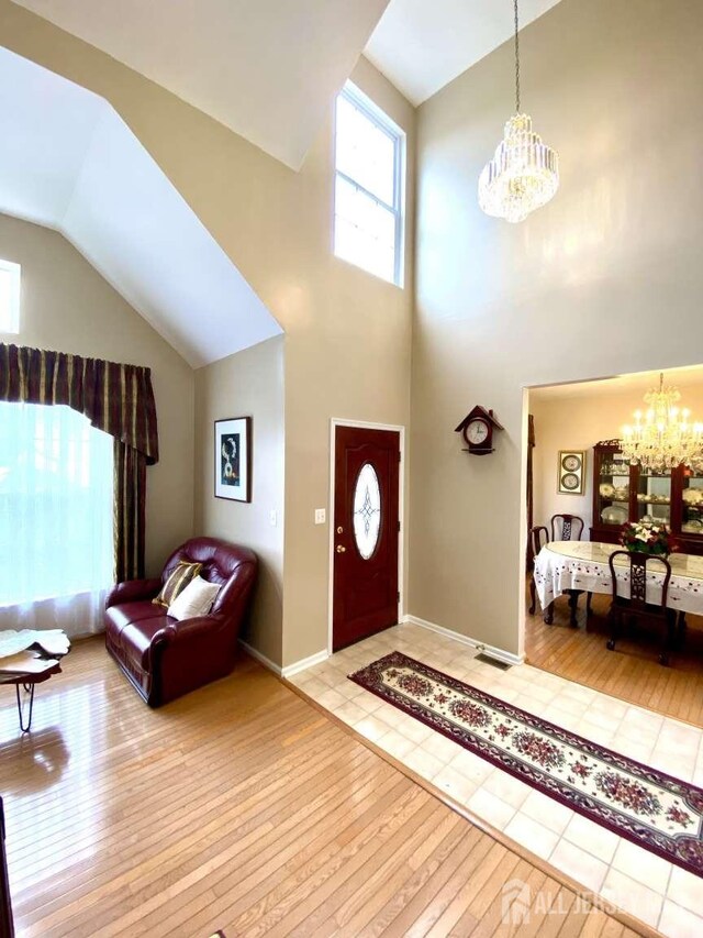 57 Yorktown Rd, South Brunswick, NJ 08852 - entryway featuring a chandelier, hardwood / wood-style floors, and high vaulted ceiling