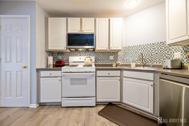 4 Linda Ct, Old Bridge, NJ 08879 - kitchen with appliances with stainless steel finishes, white cabinetry, light wood-type flooring, and tasteful backsplash