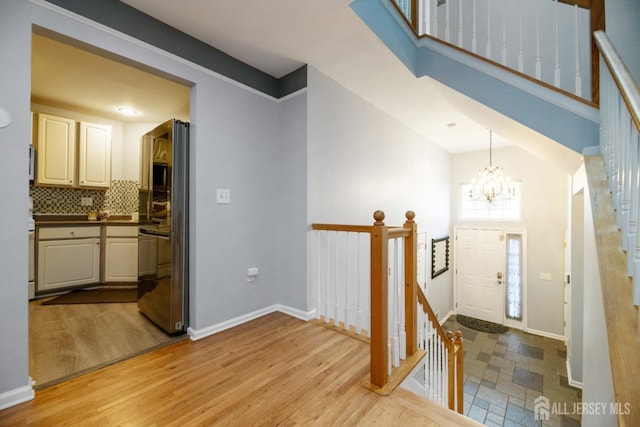4 Linda Ct, Old Bridge, NJ 08879 - foyer featuring a chandelier, light wood-type flooring, vaulted ceiling, and stairway