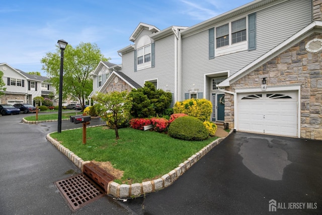 4 Linda Ct, Old Bridge, NJ 08879 - view of front of property featuring stone siding, a front yard, a residential view, and a garage