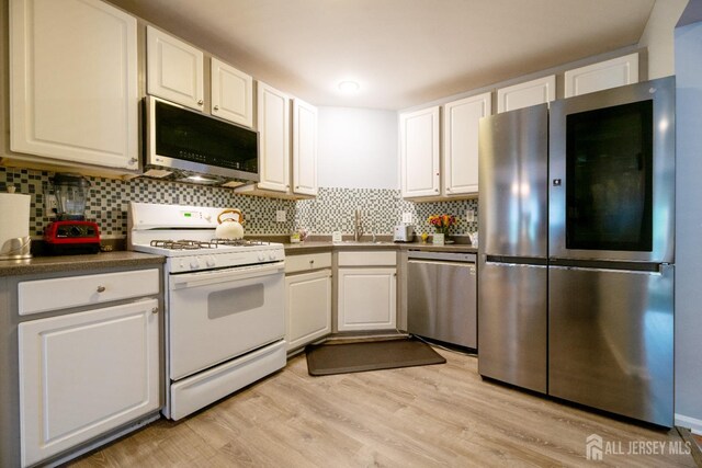 4 Linda Ct, Old Bridge, NJ 08879 - kitchen with appliances with stainless steel finishes and white cabinetry