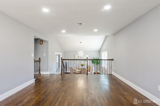 unfurnished room with recessed lighting, baseboards, dark wood-style floors, and lofted ceiling