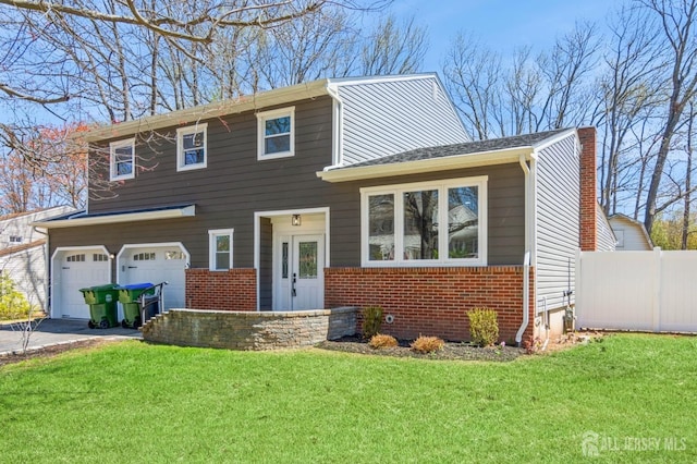 view of front facade featuring a garage, fence, a front yard, and brick siding